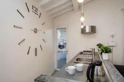 a kitchen with a large clock on the wall at Fabuloucity Fontana di Trevi in Rome
