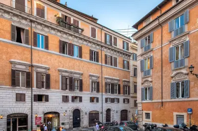 a group of buildings in a street with cars at Fabuloucity Fontana di Trevi in Rome