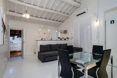 a living room with a glass table and a couch at Fabuloucity Fontana di Trevi in Rome
