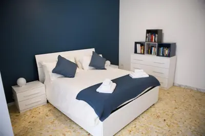a bedroom with a white bed with blue walls at Cesare a Trastevere in Rome