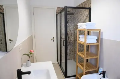 a bathroom with a shower and a sink and a mirror at Cesare a Trastevere in Rome
