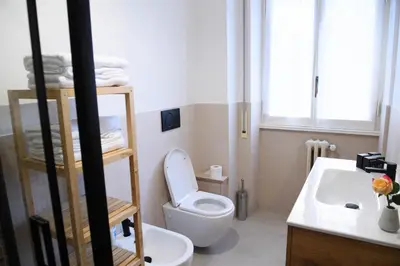 a bathroom with a toilet and a sink at Cesare a Trastevere in Rome