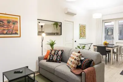a living room with a couch and a dining room at La Dimora del Gianicolo in Rome
