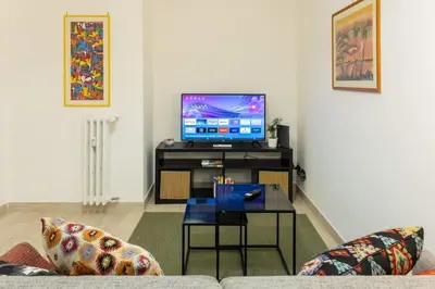 a living room with a couch and a tv at La Dimora del Gianicolo in Rome