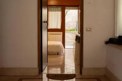 a hallway with a door leading to a bedroom at La Casetta tiny house in Rome in Rome