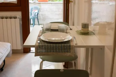 a table with chairs and a plate on top of it at La Casetta tiny house in Rome in Rome