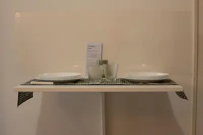 a shelf with three bowls and plates on it at La Casetta tiny house in Rome in Rome