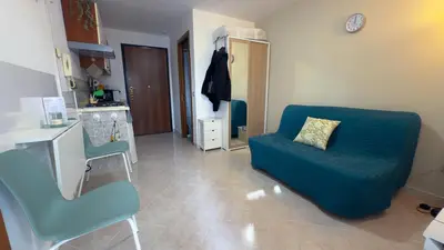 a living room with a blue couch and a chair at La Casetta tiny house in Rome in Rome