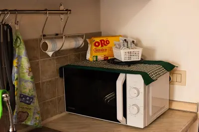 a microwave with a green top on top of it at La Casetta tiny house in Rome in Rome