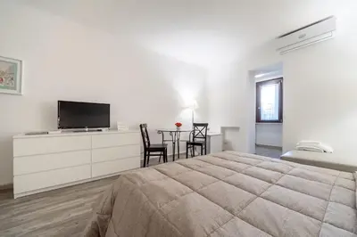 a bedroom with a bed and a tv and a table at Awesome in Rome