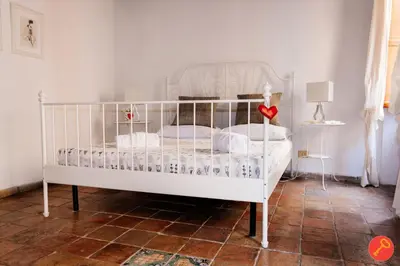 a white bed with a white crib in a room at Gorgeous House Trastevere in Rome