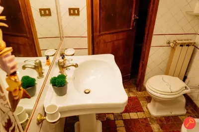 a bathroom with a white sink and a toilet at Gorgeous House Trastevere in Rome