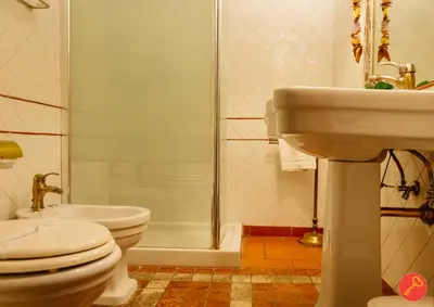 a bathroom with a toilet and a sink and a shower at Gorgeous House Trastevere in Rome