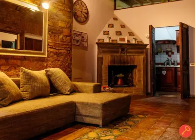 a living room with a couch and a fireplace at Gorgeous House Trastevere in Rome