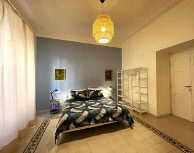 a bedroom with a bed and a chandelier at Enjoy Colosseo in Rome
