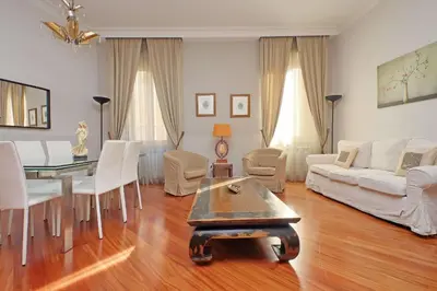 a living room with a table and a couch at Capocci by Halldis in Rome