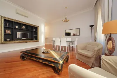 a living room with a coffee table and a dining room at Capocci by Halldis in Rome