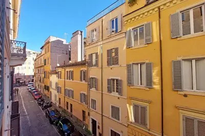 a view of an alley with buildings at Capocci by Halldis in Rome