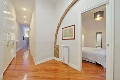a hallway with a room with a bed and an archway at Capocci by Halldis in Rome