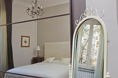 a bedroom with a canopy bed and a window at Capocci by Halldis in Rome