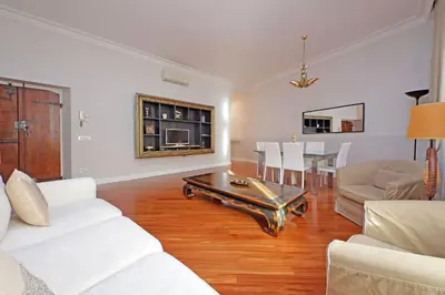 a living room with white furniture and a table at Capocci by Halldis in Rome