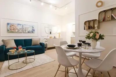 a living room with a blue couch and a table at Lady A in Rome- Luxury Apartment in Rome