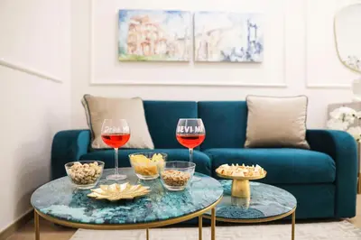 a living room with two wine glasses and a couch at Lady A in Rome- Luxury Apartment in Rome