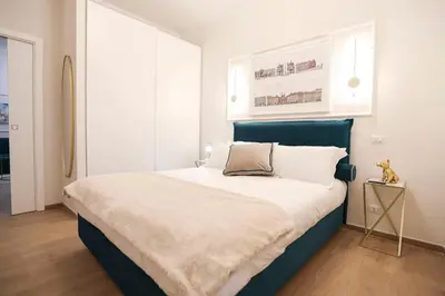 a bedroom with a large bed with a blue headboard at Lady A in Rome- Luxury Apartment in Rome