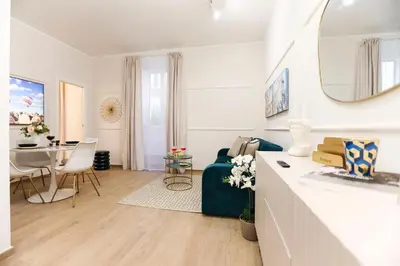 a white living room with a table and a dining room at Lady A in Rome- Luxury Apartment in Rome