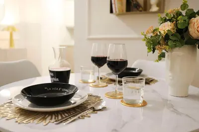 a table with two glasses of wine and a plate of food at Lady A in Rome- Luxury Apartment in Rome
