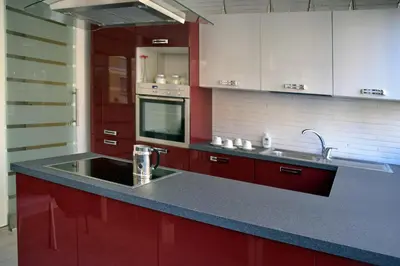 a kitchen with red cabinets and a sink at Gregori Guest House in Rome