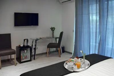 a room with a bed and a table with a tray of food at Gregori Guest House in Rome