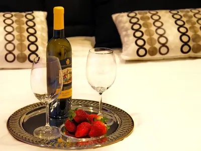 a tray with two wine glasses and strawberries on a table at Gregori Guest House in Rome