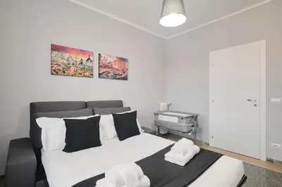 a bedroom with a bed and a piano in it at Colosseo-San Giovanni, New Apartment Wi-Fi & A-C in Rome