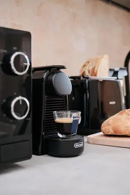 a coffee maker on a counter with a cup of coffee at Colosseo-San Giovanni, New Apartment Wi-Fi & A-C in Rome