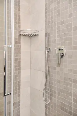 a shower with a shower head in a bathroom at Colosseo-San Giovanni, New Apartment Wi-Fi & A-C in Rome