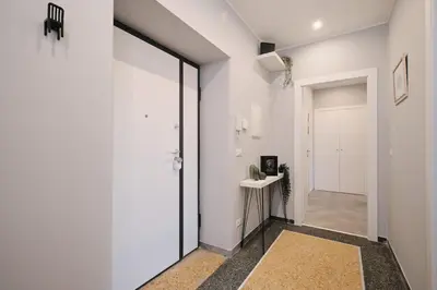 a hallway with white walls and a glass door at Colosseo-San Giovanni, New Apartment Wi-Fi & A-C in Rome