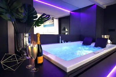 a bath tub with a bottle of wine and two champagne glasses at LUX- Spanish Steps 60A Exclusive Suite Apartment in Rome