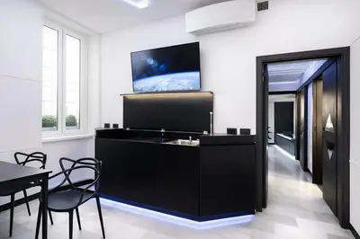 a room with a black desk with a tv on the wall at LUX- Spanish Steps 60A Exclusive Suite Apartment in Rome