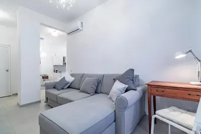 a living room with a couch and a table at Joy Home in Rome
