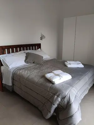 a bedroom with a bed with two towels on it at Joy Home in Rome