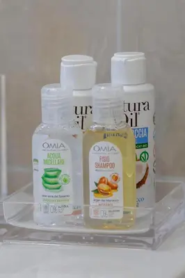a shelf with two bottles of mouthwash and other products at Joy Home in Rome