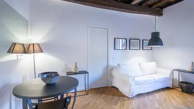 a living room with a table and a white couch at Delightful apartment-Rome Center in Rome