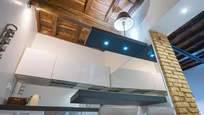 a kitchen with white cabinets and a blue counter top at Delightful apartment-Rome Center in Rome