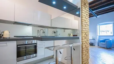 a kitchen with white cabinets and stainless steel appliances at Delightful apartment-Rome Center in Rome