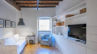 a living room with a white couch and a tv at Delightful apartment-Rome Center in Rome