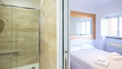 a small bedroom with a shower and a bed at Delightful apartment-Rome Center in Rome