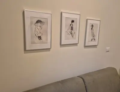 three framed drawings of women on a wall at Ripetta Views Luxury room and suite in Rome
