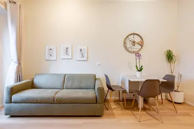 a kitchen and dining room with a table and a clock at Ripetta Views Luxury room and suite in Rome