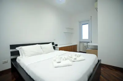 a bedroom with a white bed with towels on it at Ponte Milvio Cozy 1BR Apartment in Rome